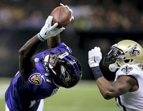 Ravens Wide Receiver Jeremy Butler reaches up to make a catch in front of a Saints defender