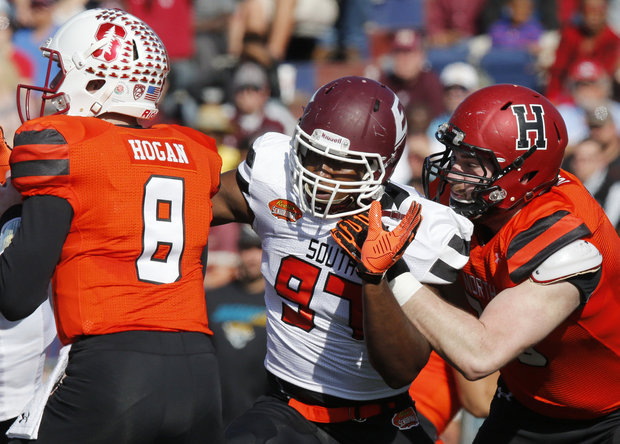 North squad offensive tackle Cole Toner of Harvard (79) fails at holding back South squad defensive end Noah Spence of Eastern Kentucky (97) when he sacks North squad quarterback Kevin Hogan of Stanford (8) in the first half during the Senior Bowl NCAA college football game, Saturday, Jan. 30, 2016, in Mobile, Ala.