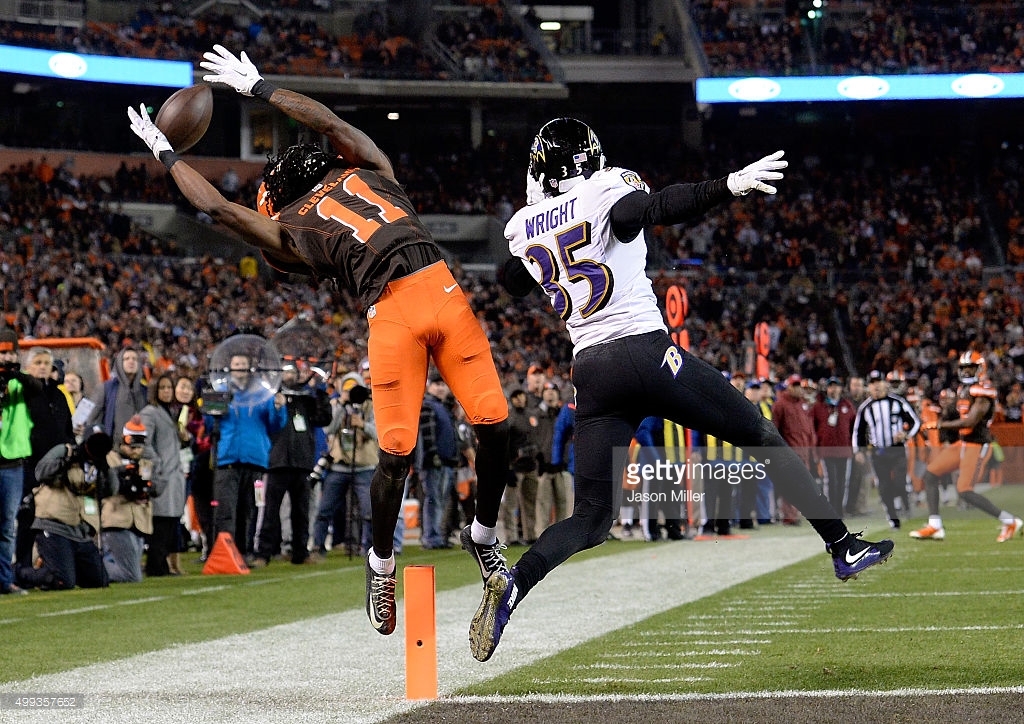 Ravens CB Shareece Wright defends in front of the pylon as Cleveland Browns WR Travis Benjamin tries to reach up for a catch as he's falling out of bounds.
