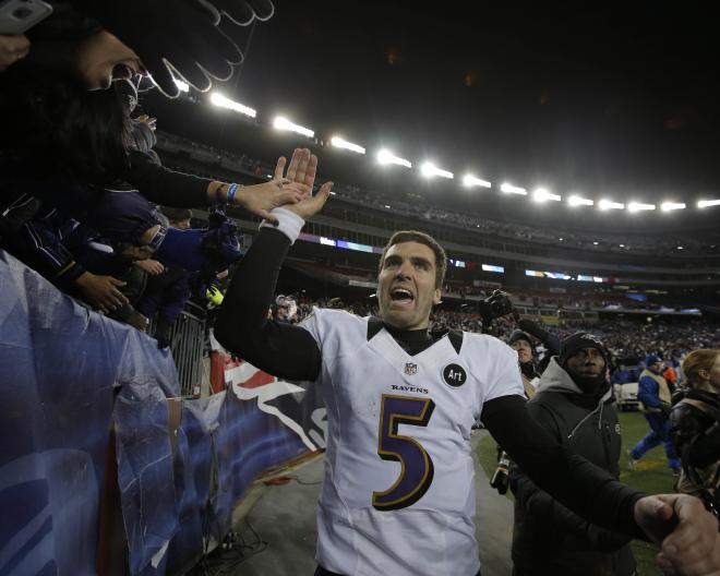 Ravens QB Joe Flacco high fives fans after winning the AFC Championship game in New England, on his way to the Super Bowl.