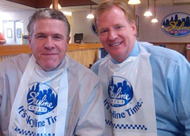 Roger Goodell and Peter King wearing bibs to eat at a seafood restaurant.