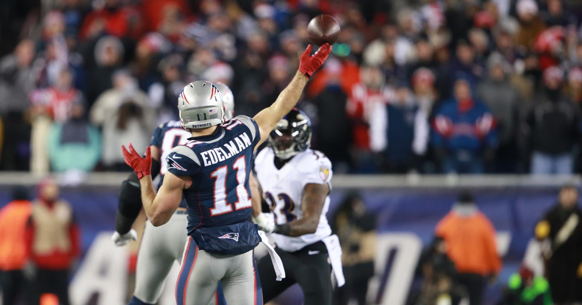 Patriots WR Julian Edelman throws a touchdown pass over the Ravens defense.