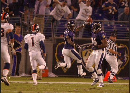 Chris McAlister scores a touchdown as Broncos players chase.