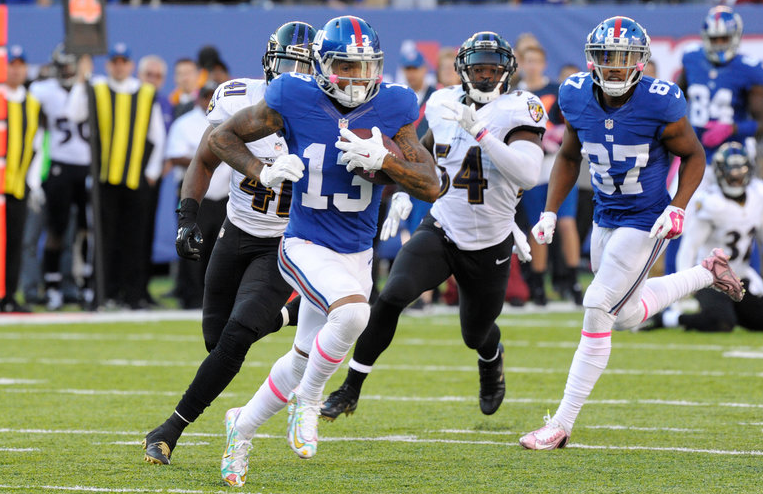 Odell Beckham runs as Anthony Levine and Zach Orr give chase.