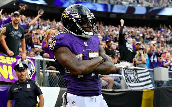 Ravens WR Mike Wallace stands with his arms folded.