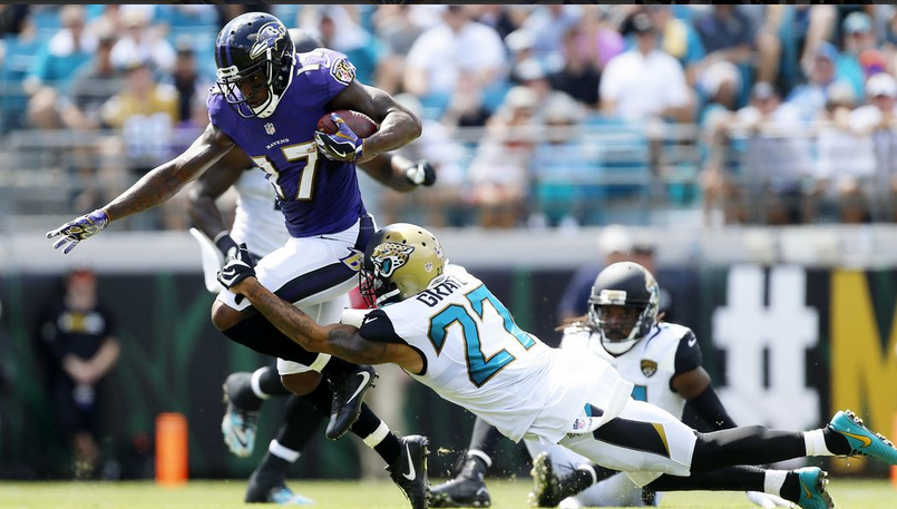 Mike Wallace jumps over Jaguars defenders.