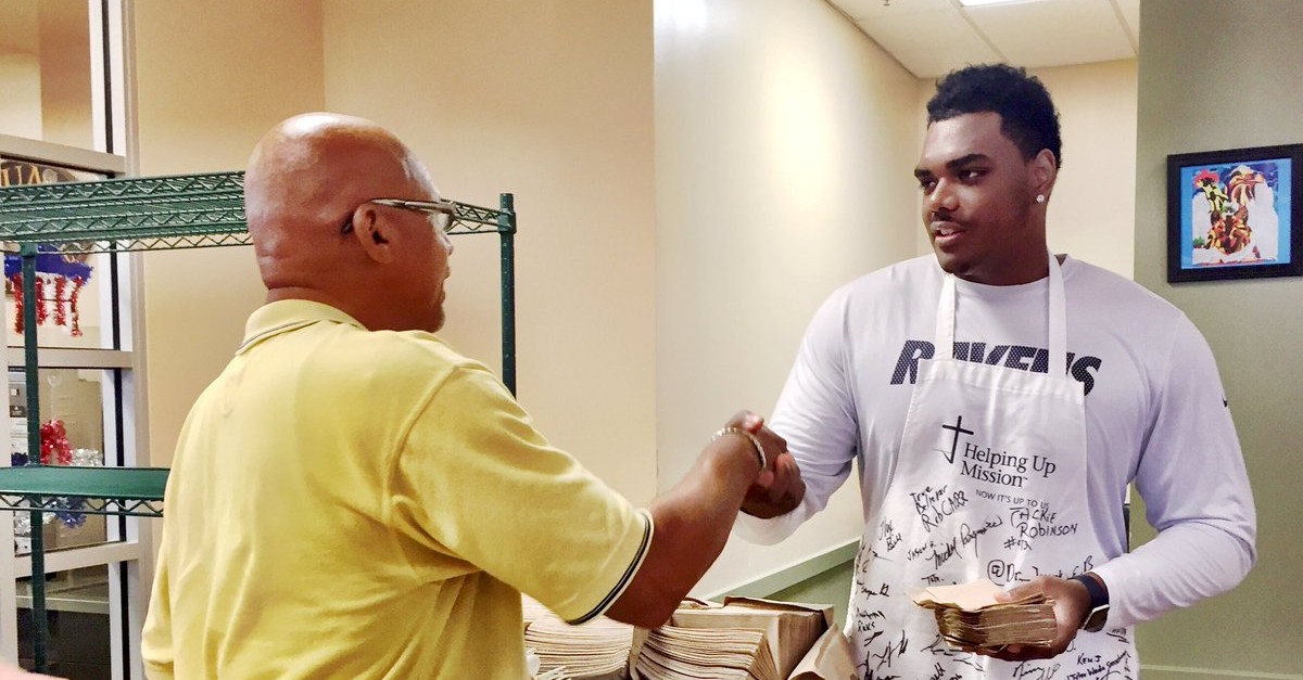 Ravens Rookie OT Ronnie Stanley shakes hands with a man at Helping Up Mission in East Baltimore.