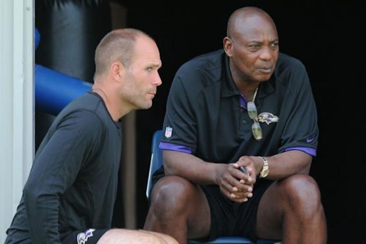 Eric DeCosta and Ozzie Newsome sit and watch.