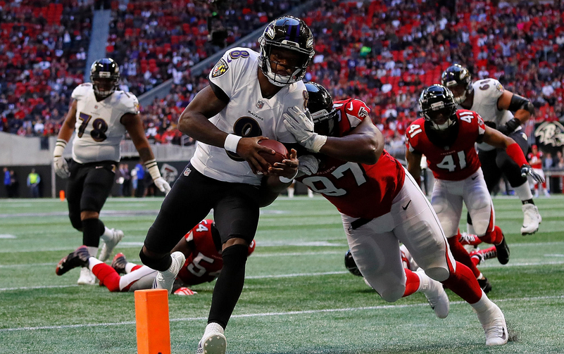 Lamar Jackson scoots by the pylon as the Falcons try to stop him.