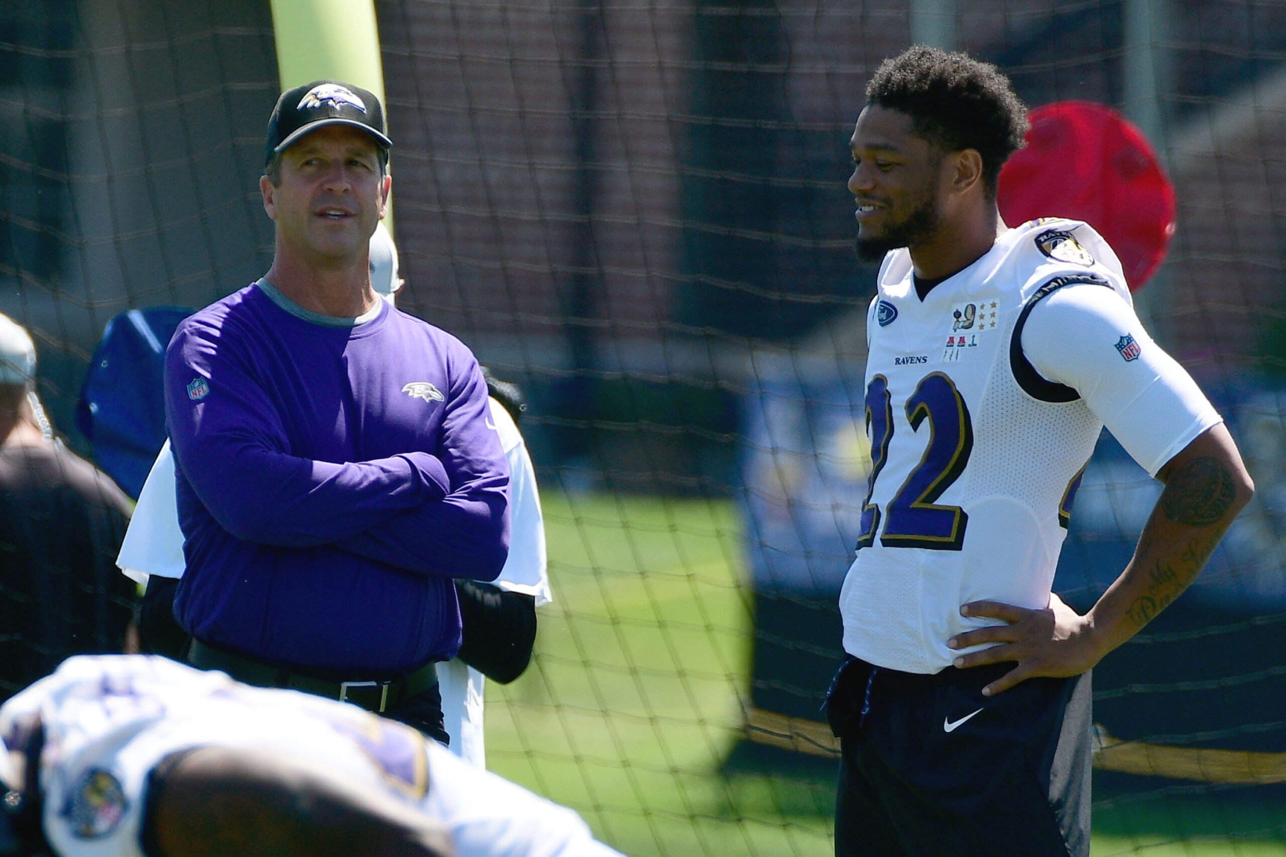 John Harbaugh and Jimmy Smith chat at practice.