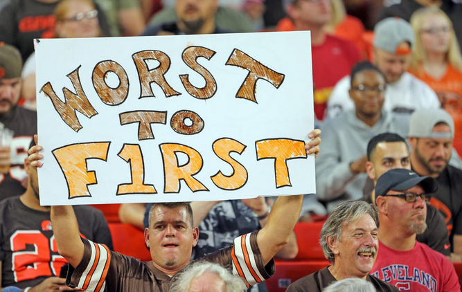 A Browns fan holds a worst to first sign.