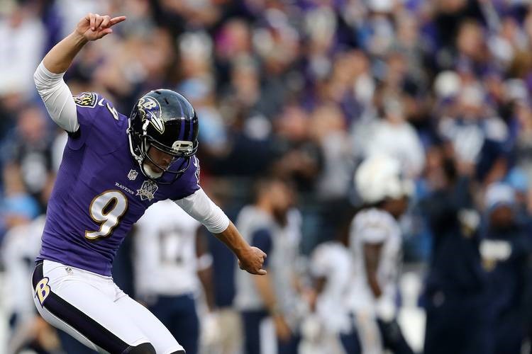 Justin Tucker points to the ground and up in the air as he does the Hotline Bling Drake dance