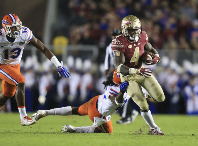 Florida State RB Dalvin Cook runs past Florida defenders.