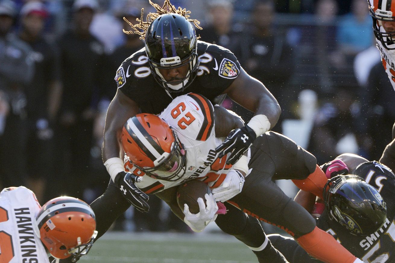 Za'Darius Smith of the Ravens tackles a Browns player with the ball.