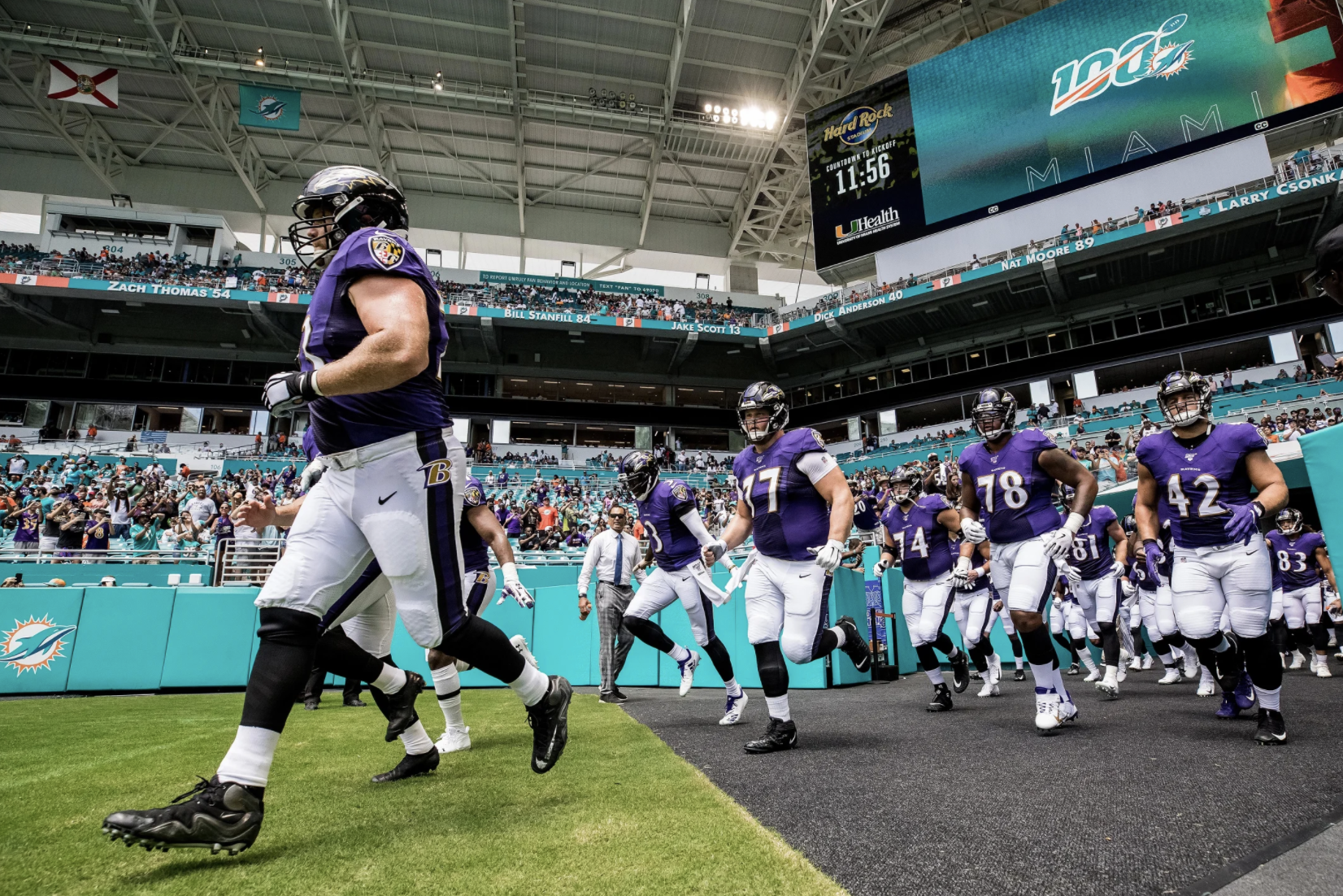 The Ravens run out of the tunnel in Miami against the Dolphins