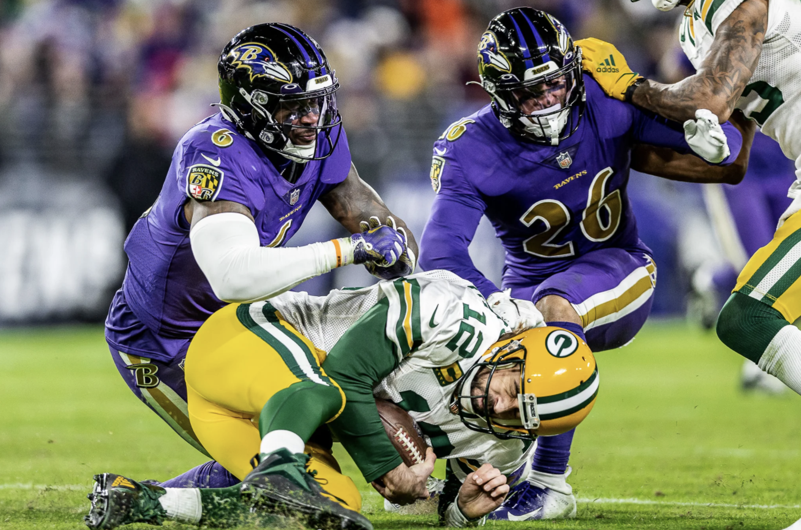 Dec 19, 2021; Baltimore, Maryland, USA; Green Bay Packers quarterback Aaron Rodgers (12) is tackled in the second quarter while defended by Baltimore Ravens linebacker Patrick Queen (6) at M&T Bank Stadium. Mandatory Credit: Mitch Stringer-USA TODAY Sports (NFL)