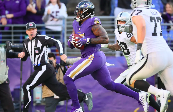 Terrell Suggs runs with the ball against Oakland.