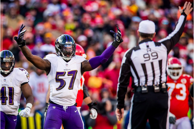 C.J. Mosley raises his arms at the referee.