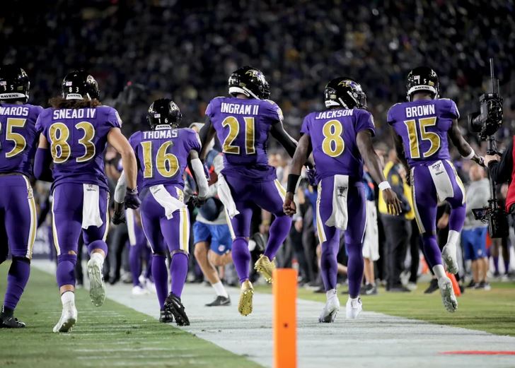 The Ravens offense jogs off the field after a TD vs. the Rams.
